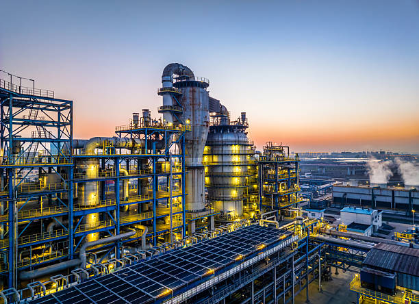 Refinery towers and tanks at dusk